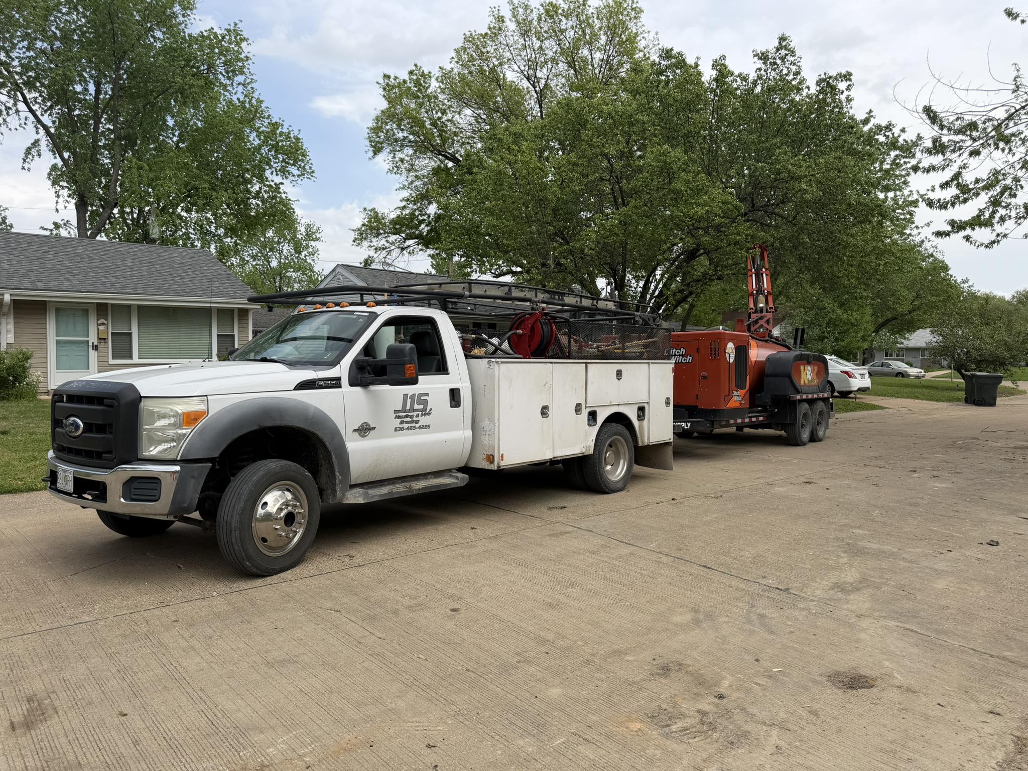 A J1S service truck parked at a house