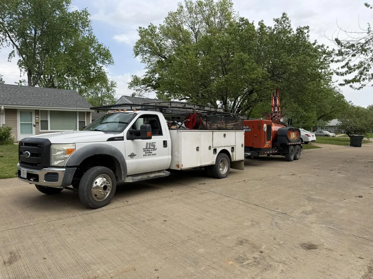 A J1S service truck parked at a house